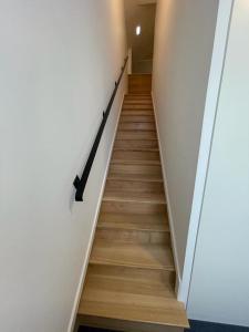 a stairway with a black hand rail and wooden floors at PIER HOUSE Accommodation in Funchal
