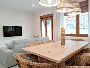 a living room with a wooden table and chairs at Villa Thálassa in Benicarló