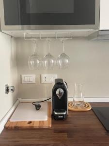 a kitchen counter with a toaster and wine glasses at IL BARICENTRO in La Spezia