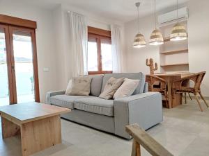 a living room with a couch and a table at Villa Thálassa in Benicarló