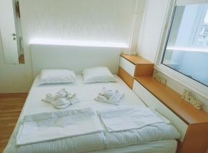 A bed or beds in a room at Апартамент Арена Бургас