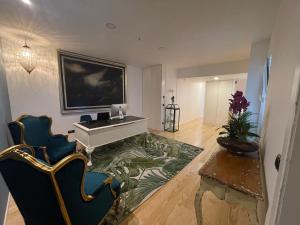 a living room with a white table and chairs at PIER HOUSE Accommodation in Funchal