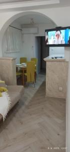 a living room with a couch and a flat screen tv at Apartmani Glorija in Arandelovac +31 photos