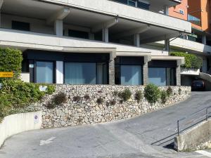 a stone wall in front of a building at Torre del mare Rooms in Bergeggi