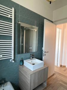 a bathroom with a sink and a mirror at Orti di Serapo -VERDE in Gaeta +10 photos