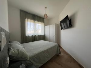 a small bedroom with a bed and a window at Orti di Serapo -VERDE in Gaeta