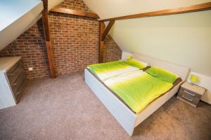 a bedroom with a bed and a brick wall at Apartmán Dvorce in Stráž nad Nežárkou