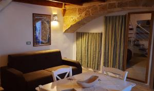 a living room with a couch and a table at Casa vacanze salento Vicosoluna in Morciano di Leuca