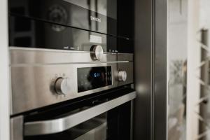 a stainless steel oven in a kitchen at Apartament Villa Klar in Ostróda