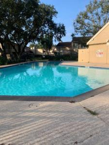 a large blue swimming pool in a yard at Entire 3 Bedroom Home Near Downtown King bed in Houston