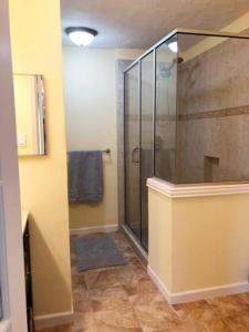 a bathroom with a shower with a glass door at Entire 3 Bedroom Home Near Downtown King bed in Houston