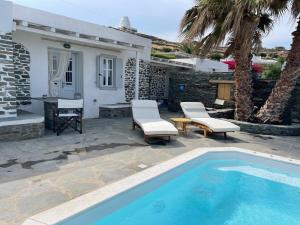 a patio with a swimming pool and a house at Efthymia Suites in Faros