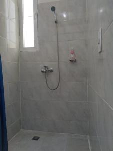 a shower with a shower head in a bathroom at RECIDENCIAL MIGNOLI in Boca Chica +30 photos