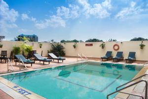 a swimming pool on the roof of a hotel at Hotel Grand Continental Kuching in Kuching