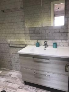 uma casa de banho com um lavatório e um espelho em Cozy apartment in Los Cristianos em El Guincho
