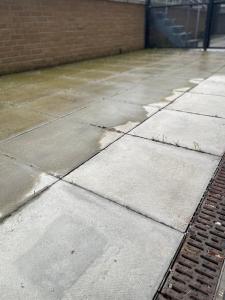 a concrete sidewalk with a building in the background at NewSuites in London