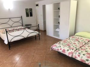 a bedroom with two beds and a cabinet at Apartments Roberta in Novigrad Istria