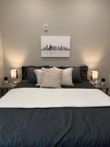 a bedroom with a large bed with two lamps at Modern 1BD Studio Apt in Plaza Midwood with Community Pool in Charlotte