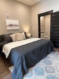 a bedroom with a large bed with a black headboard at Modern 1BD Studio Apt in Plaza Midwood with Community Pool in Charlotte