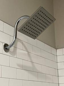 a shower head on the wall of a bathroom at Modern 1BD Studio Apt in Plaza Midwood with Community Pool in Charlotte