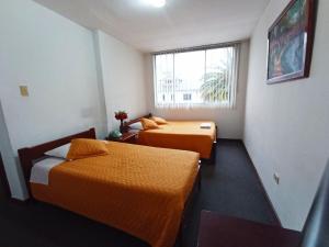 Postel nebo postele na pokoji v ubytování Hotel 9 de Octubre