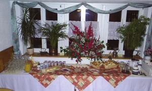 a table with a white table cloth with food on it at Pension Sonne in Rickenbach