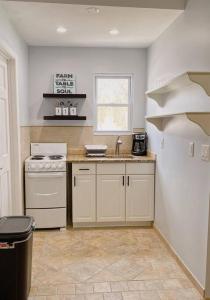 a kitchen with a white stove and a sink at Private Apt King Suite, L.I, NY-Hamptons to NYC in Coram