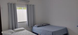 Giường trong phòng chung tại Oásis do Prado, casa de temporada +16 ảnh