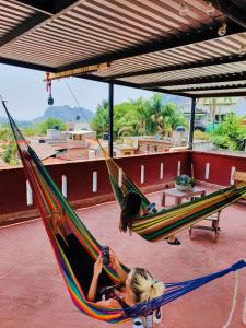 two girls laying in hammocks on a roof at Mi Atardecer en Tepoz, Hostal in Tepoztlán