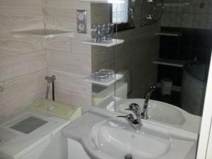 a white bathroom with a sink and a mirror at Chalet confort en montagne, près des thermes et circuits de rando, idéal pour famille - FR-1-589-135 in Le Val-dʼAjol +8 photos