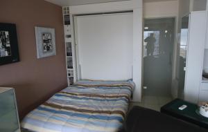 a bedroom with a door with a bed in it at Residentie Zon & Zee Ref 20 in Ostend