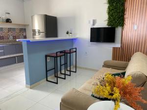 a kitchen with a blue island in a living room at Village Caranguejo - Flat com 02 Quartos in Aracaju