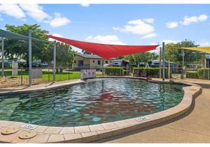 a swimming pool with a red sheet over it at Discovery Parks - Ayr in Ayr