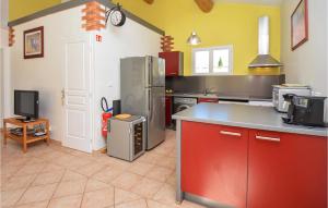 a kitchen with a refrigerator and a tv in it at Awesome Home In Cabannes With 2 Bedrooms, Wifi And Outdoor Swimming Pool in Cabannes