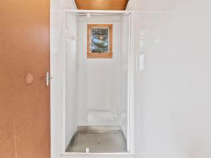 a white cabinet with a glass door with a window at Lake Edge Cottage - Waitahanui Holiday Home in Waitahanui +20 photos