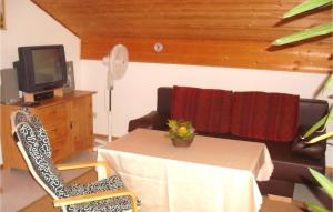 a room with a table and a tv and a table and chairs at Awesome Apartment In Nesselwang With Kitchenette in Nesselwang