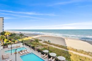 a view of the beach from the balcony of a resort at Grande Beach Resort in Myrtle Beach