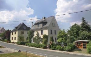 a large white house on the side of a street at Beautiful Apartment In Bad Schlema Ot Wildb, With Kitchen in Schneeberg