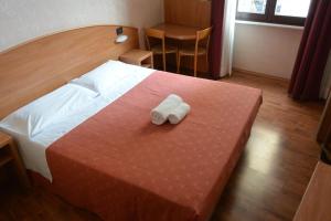 una camera d'albergo con un letto e due asciugamani di Hotel Nuovo a Milano