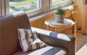a couch with a pillow on it next to a window at Holiday Home Zum Anleger I in Hohen Wieschendorf