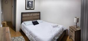 a bedroom with a bed and a dresser at Jazz on Columbus Circle Hostel in New York