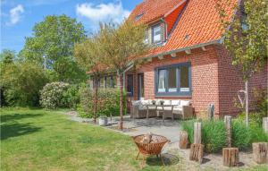 a brick house with a bench and a yard at Nice Home In Cadenberge With Sauna in Cadenberge