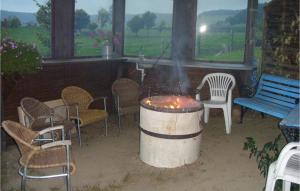 a fire pit in a patio with chairs and a bench at Beautiful Home In Medebach-ddinghausen With 6 Bedrooms And Wifi in Medebach