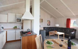 a kitchen and a living room with a table at Strandblick 33 in Schönhagen