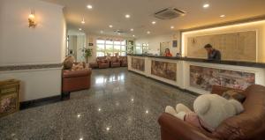 a lobby with couches and a bar in a building at 1 Million Hotel in Johor Bahru