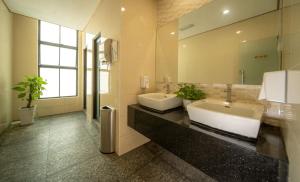 a bathroom with two sinks and a large mirror at 1 Million Hotel in Johor Bahru