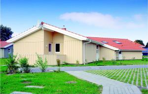 a yellow building with a red roof at Strandpark 20 in Schönhagen