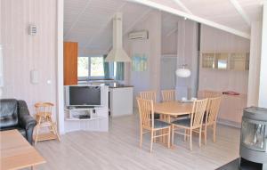 a kitchen and dining room with a table and chairs at Strandblick 10 - Dorf 1 in Travemünde