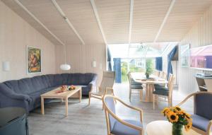 a living room with a blue couch and a table at Strandblick 12 - Dorf 1 in Travemünde