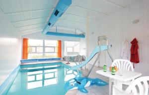 a swimming pool with a slide in a room at Strandblick 5 - Dorf 1 in Travemünde
